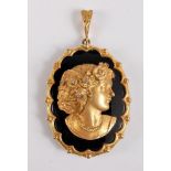 A 9ct diamond and onyx pendant, the oval black onyx pendant set with a 9ct relief bust of a maiden