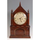 An early Victorian rosewood cased bracket clock, having Gothic influenced case, convex white