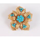 An 18ct turquoise brooch, the central turquoise cabochon cluster, set as the centre of five out