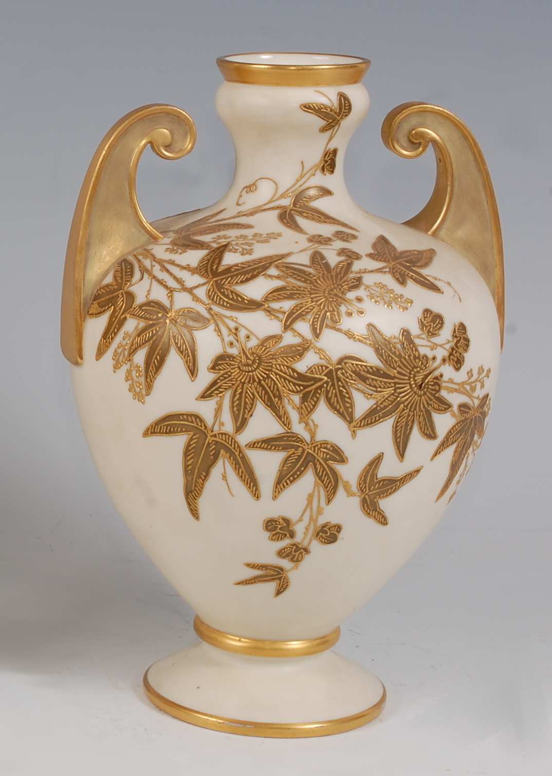 *A Royal Worcester porcelain twin handled vase, of baluster form, on an ivory ground with raised