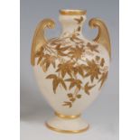 *A Royal Worcester porcelain twin handled vase, of baluster form, on an ivory ground with raised