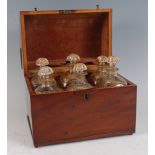 A Victorian mahogany fitted decanter box, the cover opening to reveal six square spirit decanters