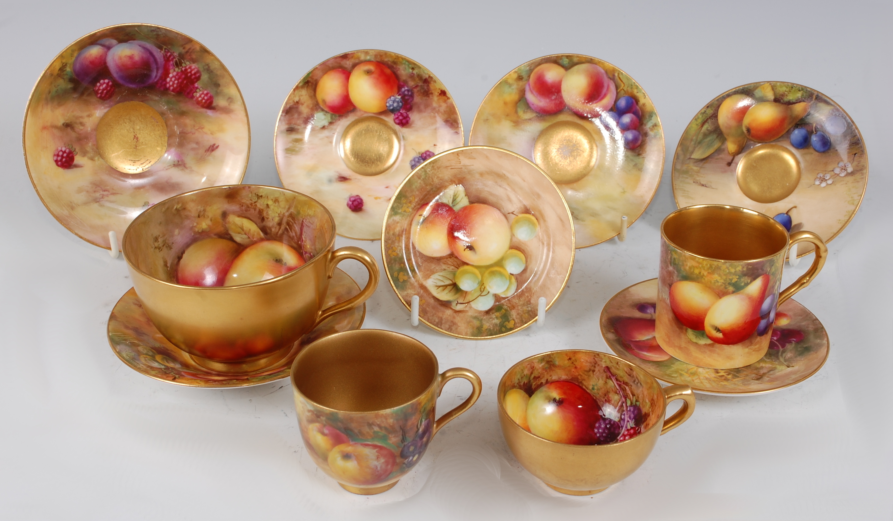 *A Royal Worcester porcelain teacup and saucer, the teacup hand-painted with apples and