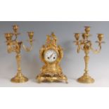 A Rococo Revival gilt metal three-piece clock garniture, the clock of balloon shape, the swept
