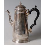 A late Victorian silver coffee pot, of plain tapered cylindrical form, having ebonised flying C-