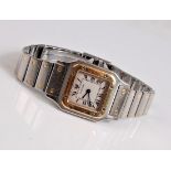 A lady's Cartier 18ct gold and steel Santos wristwatch, with off-white square dial with black