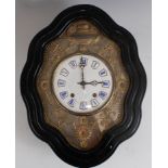 A late 19th century French comtoise wall clock, the shaped ebonised case enclosing a white enamel