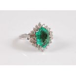 An 18ct and platinum emerald and diamond ring, the hexagonal step cut emerald, approx. 13.8 x 8.9mm,