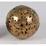 An early 19th century pierced and engraved brass incense ball, decorated as flowers and foliage,