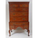 A George III oak chest-on-stand, having a cavetto cornice over two short and three long drawers, the