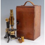 A late 19th century lacquered brass monocular microscope, having single eye-piece, two objectives,