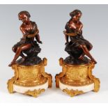 A pair of mid-19th century French bronze figures of a young boy and girl, each seated and dressed in