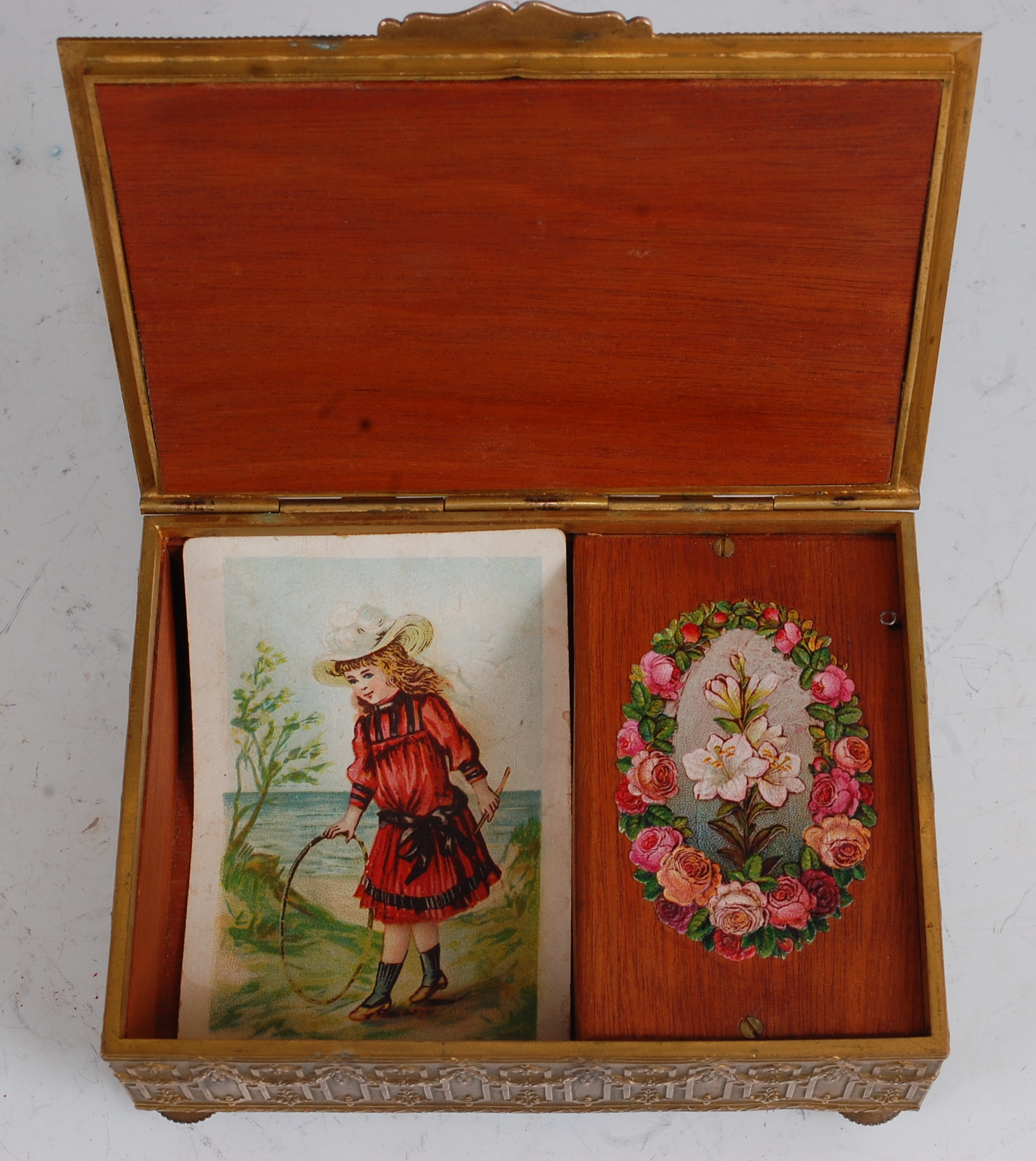 A late 19th century brass music box, the hinged cover cast with a scene of merry-making and - Image 3 of 3