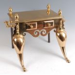 A Regency heavy brass footman, having twin end carry handles, the frieze with twin dummy drawers,