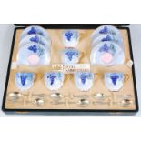 *A cased set of six Royal Worcester coffee cups and saucers, each piece on a light blue ground