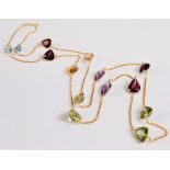 A multi gemset necklace, the mixed cut gemstones comprising topaz, garnet, citrine, peridot,