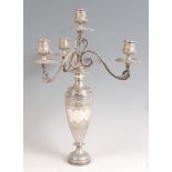 A Victorian silver four light candelabrum, the candle holders each modelled as half-reeded