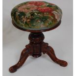 *A Victorian rosewood pedestal piano stool, the circular floral embroidered stuffover revolving seat