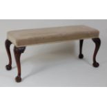 *A Georgian style mahogany duet stool, having green draylon upholstered stuffover seat, on