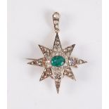 An emerald and diamond star pendant / brooch, the central oval emerald, approx. 7.8 x 5.7mm, set