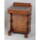 A Victorian figured walnut kneehole writing Davenport, having hinged fitted stationery