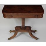 A Regency mahogany and ebony strung card table, the D-shaped fold-over top revealing a baize lined