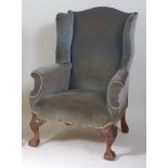 A walnut framed wing armchair in the early 18th century style, the whole for re-upholstery but