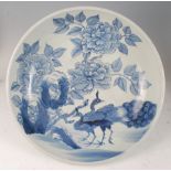 A Chinese export blue and white bowl, of good size, decorated with peacocks in a landscape, with six