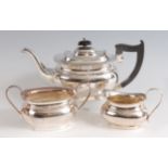 A Georgian style silver three-piece tea set, comprising teapot, twin handled sugar and cream, each