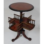 *A Victorian amboyna, ebonised, and parcel gilt book table, the circular top on a turned column
