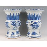 A pair of Chinese export blue and white vases, the flared necks each painted with stiff leaves,