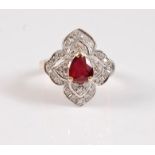An 18ct ruby and diamond ring, the central trilliant cut ruby surrounded by four two tier diamond