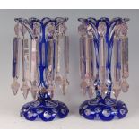 A pair of late 19th century blue overlaid glass lustres, each of waisted form and with faceted cut