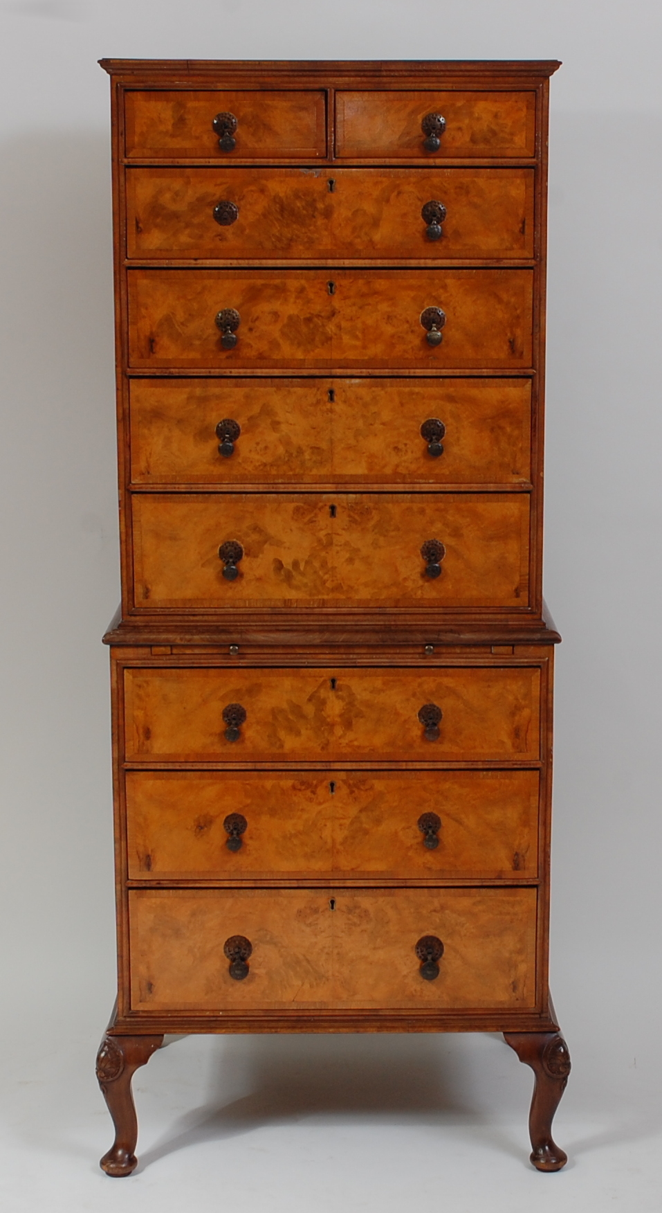 A figured walnut and crossbanded chest-on-chest, of small proportions, in the early 18th century