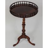 *A Georgian style mahogany pedestal tripod table, the associated circular tilt-top with turned