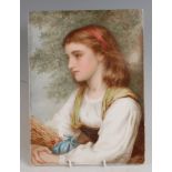 A 19th century painted porcelain plaque, depicting a half-length portrait of a harvest girl with