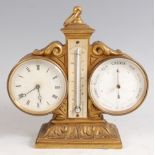 A circa 1900 gilt metal combination clock barometer and thermometer, having a centre ring carry