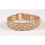 A tri-coloured gold bracelet, the alternating bands of tri-coloured textured gold interwoven with
