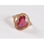 A 14k heart shaped ruby and diamond ring, the heart shaped ruby, set at 90 degrees to the band,