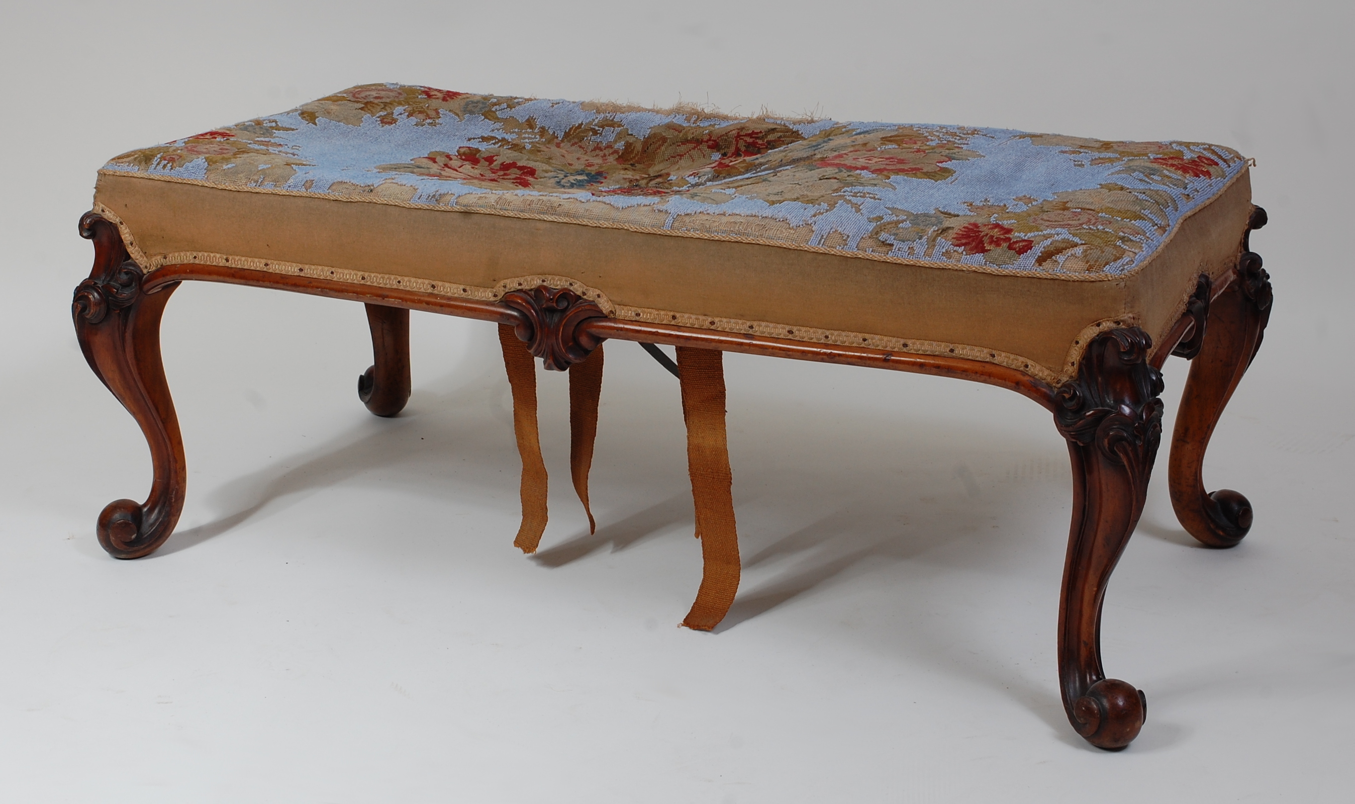 *A Victorian rosewood framed duet dressing stool, the rectangular stuffover seat having floral