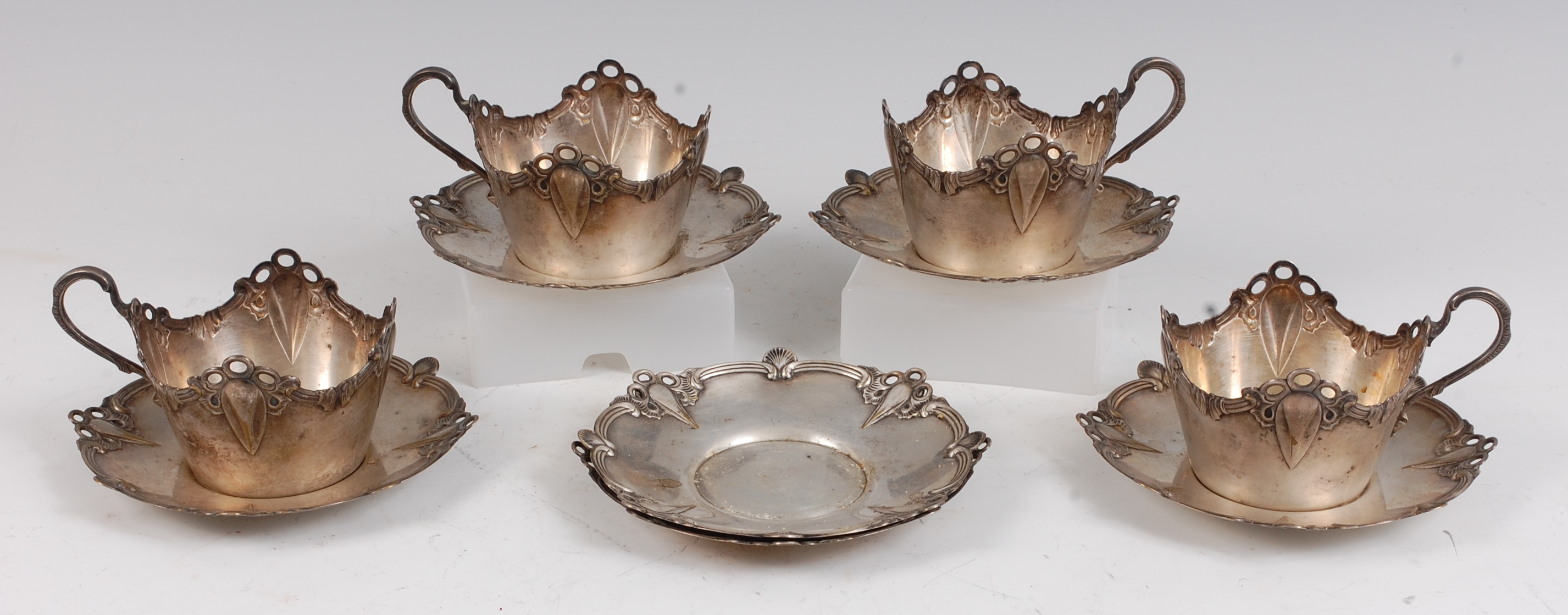 A set of four WMF Art Nouveau white metal teacup holders, dia.9cm; together with a matching set of
