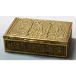 An Eastern brass table cigarette box, of rectangular form, the lid relief decorated with cherubs