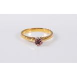 An 18ct gold pink tourmaline solitaire ring, the round pink tourmaline, approx. 4.3mm diameter, claw