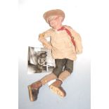 A mid 20th century carved wooden puppet in the form of a man with jointed body with photograph of