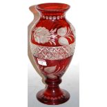 A Bohemian style ruby overlaid glass vase, of baluster form, etched with flowers and foliage, h.