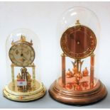 A 1970s Kundo anniversary clock under dome, h.24cm; together with a lacquered brass and copper