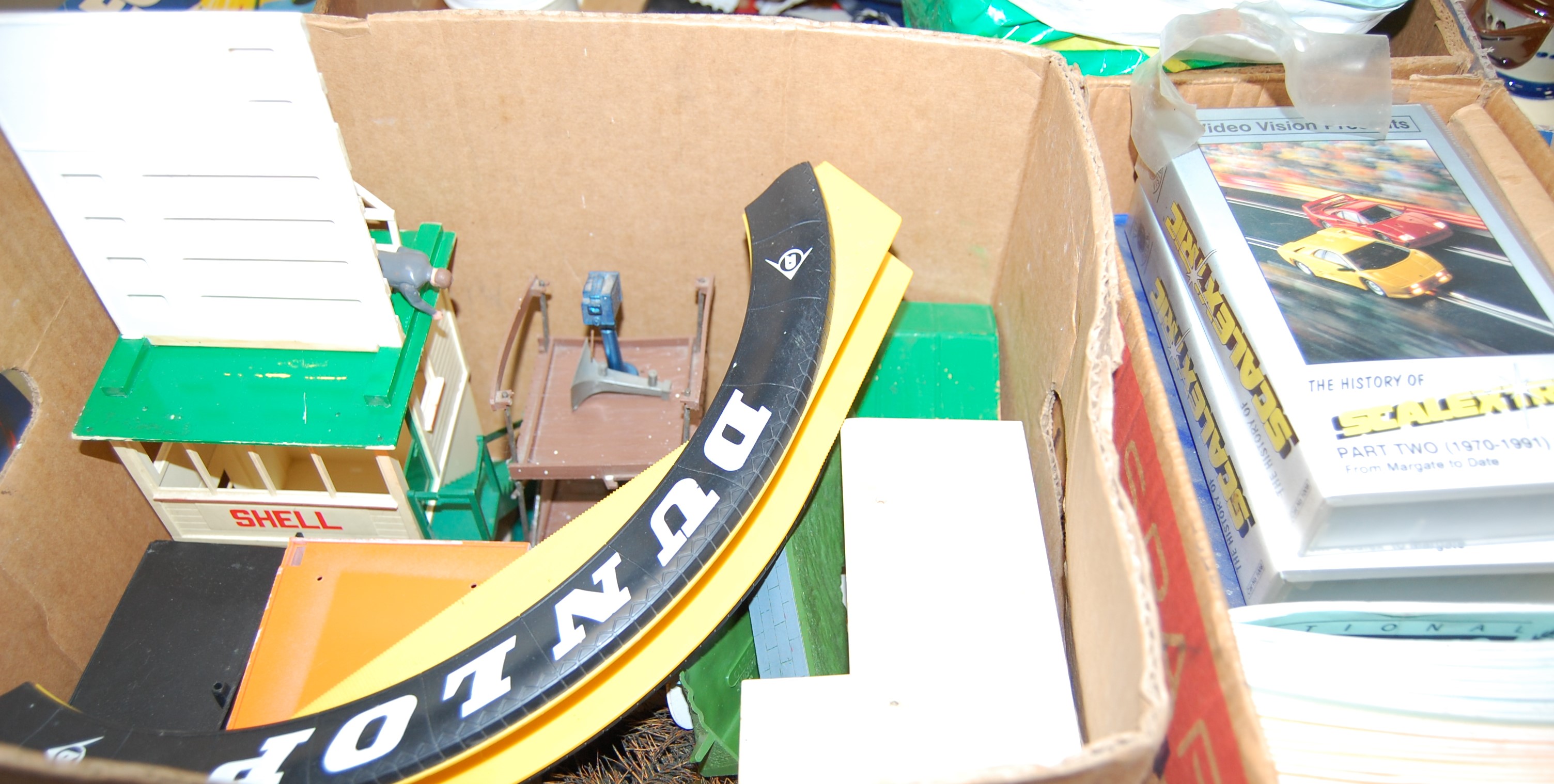 Three boxes of Scalextric accessories, to include Dunlop bridge, track, magazines and videos etc