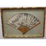 A mid-20th century hand-decorated Japanese fan, having Japanese script and depicting a dining/