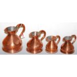 A set of four 19th century copper jugs, to include pint, half-pint and quarter gil, tallest 16cm