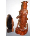 A carved wooden hand Mudra, h.30cm; together with a large carved wooden figure of a deity (2)
